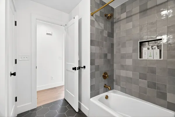 a bathroom with a bathtub and a shower