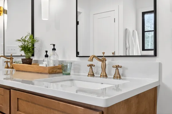a kitchen with kitchen island a sink and a mirror