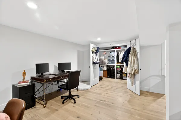 a view of a workspace with furniture and a window