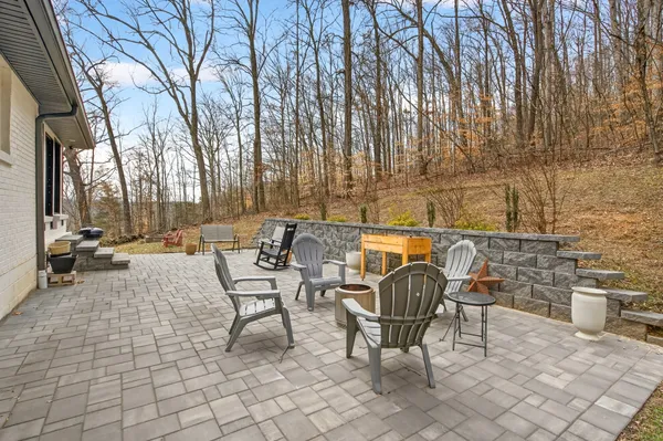 a view of a patio with table and chairs and couches