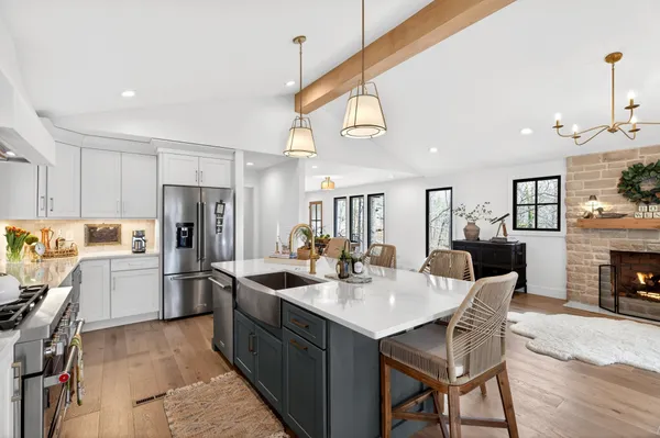a kitchen with refrigerator cabinets dining table and chairs