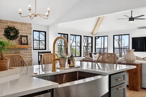 a kitchen with granite countertop a sink and a refrigerator