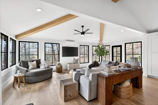 a living room with furniture and large windows