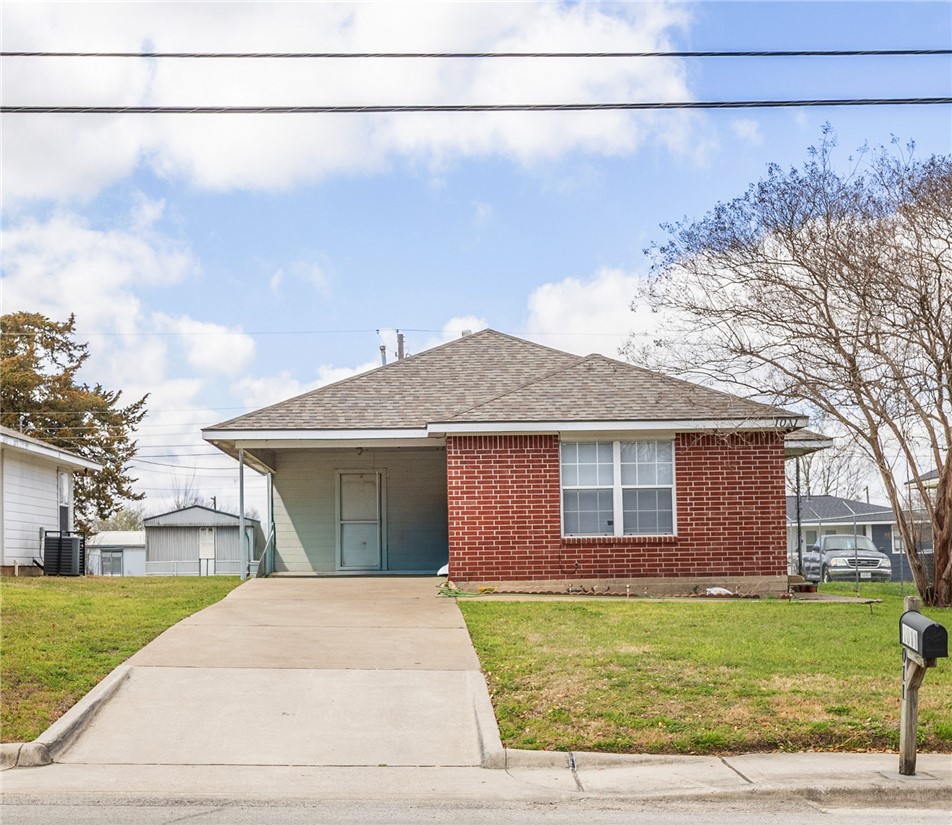 1011 West 17th Street Bryan, TX 77803 - Photo 1 of 6 a front view of a house with a yard and garage