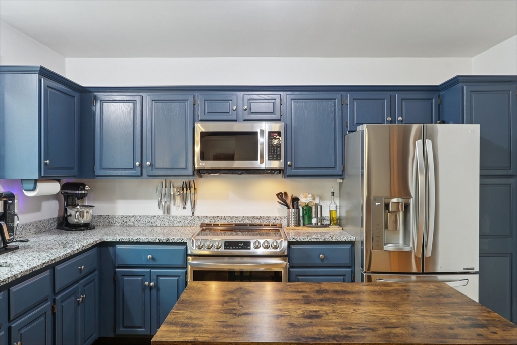 19 Roosevelt Road Plymouth, MA 02360 - Photo 11 of 35 a kitchen with granite countertop wooden cabinets and stainless steel appliances
