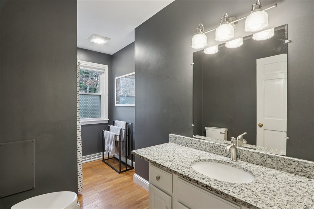 19 Roosevelt Road Plymouth, MA 02360 - Photo 24 of 35 a bathroom with a granite countertop sink a toilet and mirror