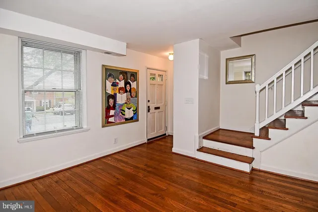 a view of entryway with wooden floor and window