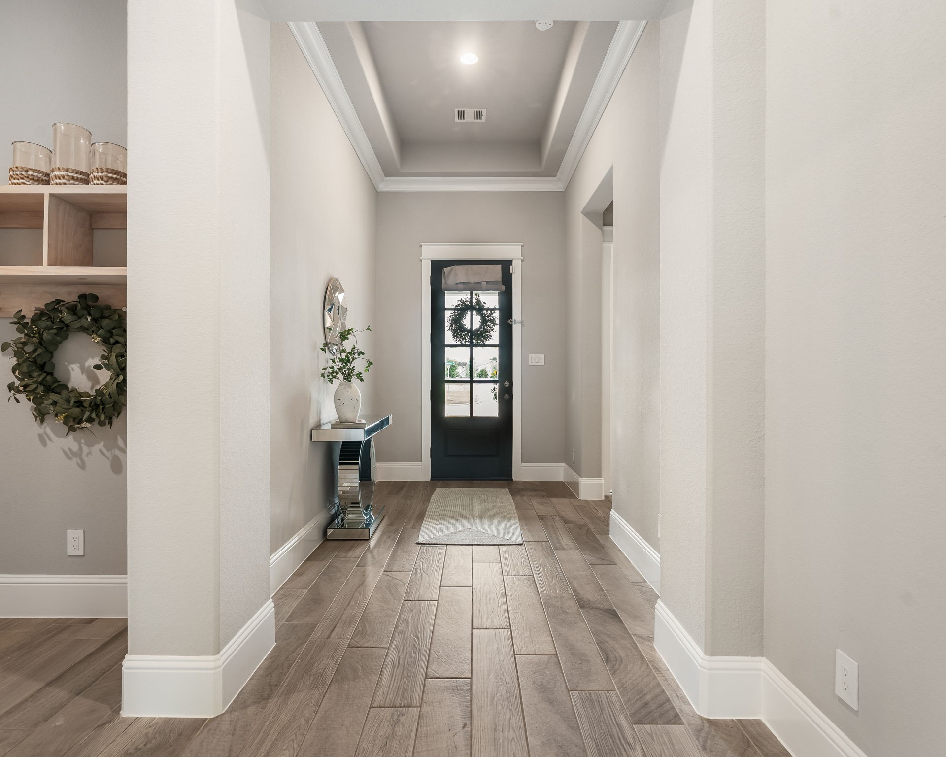 2206 Rope Maker Road Conroe, TX 77384 - Photo 5 of 42 Grand entry foyer with soaring ceilings, wood-look tile flooring, and elegant natural light.