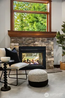 a living room with furniture a fireplace and a window