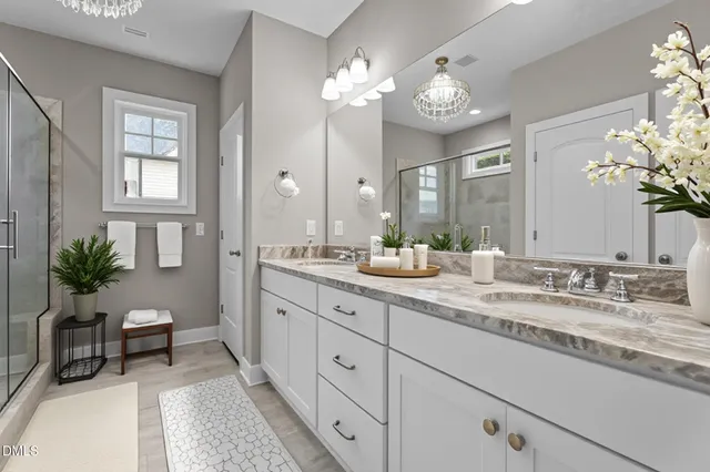 a view of an empty room with wooden floor fireplace and a window
