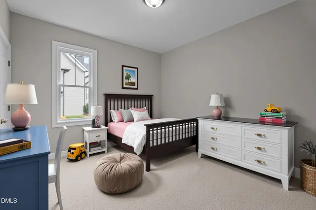 a view of an empty room with wooden floor fireplace and a window