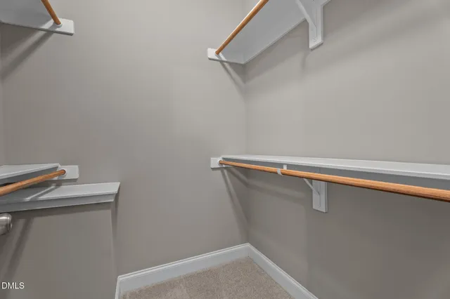 a view of a house with a yard plants and a garage