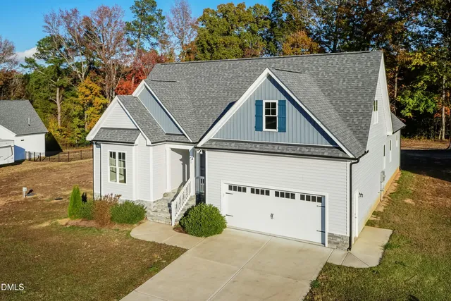 a view of a dining room with furniture a chandelier and wooden floor