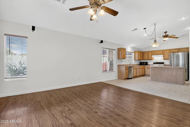 a view of a kitchen with furniture and wooden floor