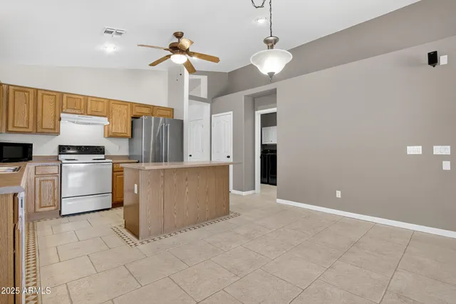 a large kitchen with cabinets and stainless steel appliances