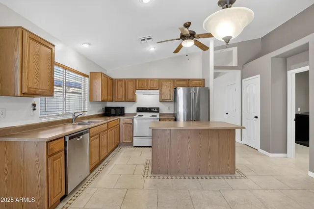 a kitchen with a sink cabinets and window