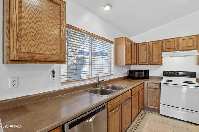 a kitchen with stainless steel appliances granite countertop a refrigerator sink and cabinets