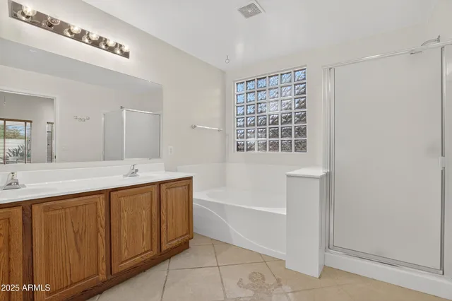 a bathroom with a tub a sink and a mirror