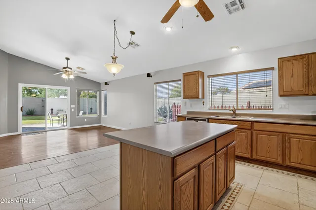 a kitchen with a sink cabinets and wooden floor