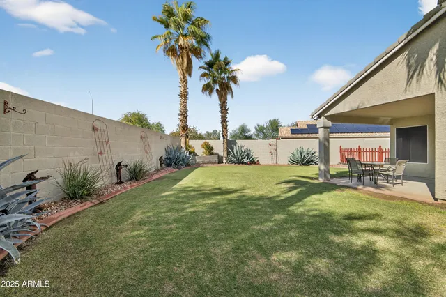 a view of swimming pool with table and chairs