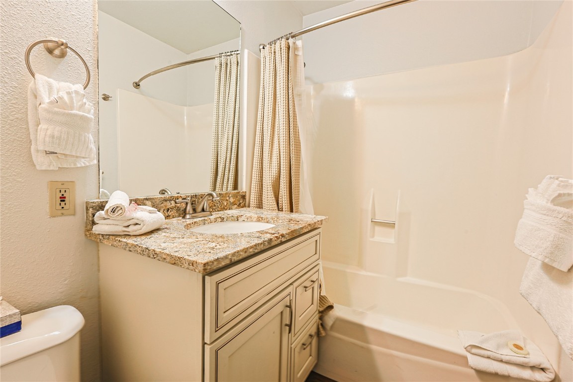 214 Ten Mile Circle, Unit R310 Copper Mountain, CO 80443 - Photo 9 of 15 a bathroom with a granite countertop sink toilet and shower