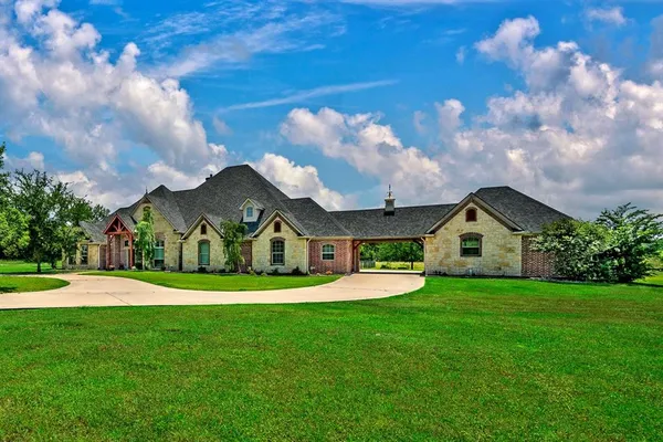 a front view of house with yard and green space