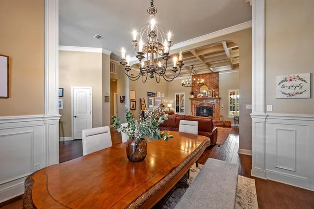 a dining room with furniture and chandelier