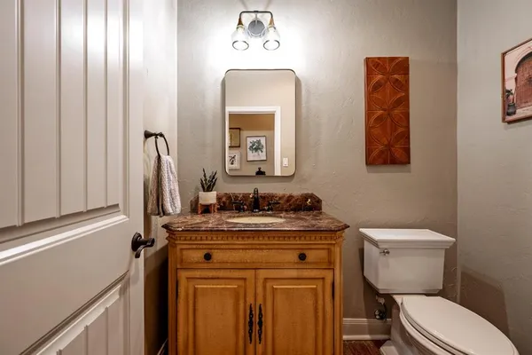 a bathroom with a toilet a sink and mirror