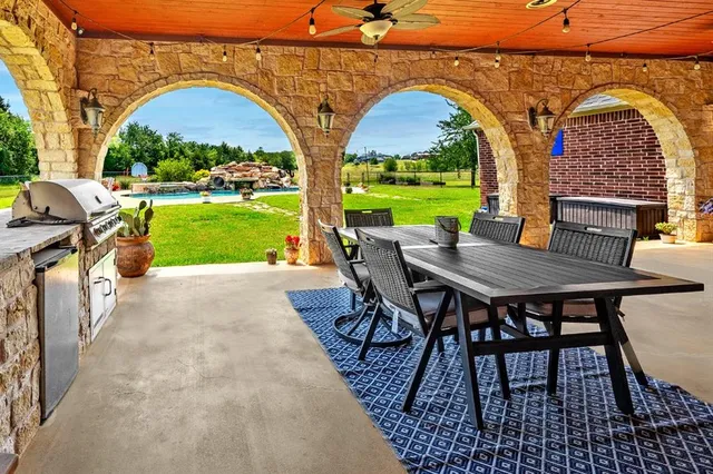 swimming pool view with a seating space and a garden