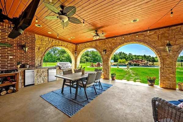 a view of a patio with a table chairs and a backyard