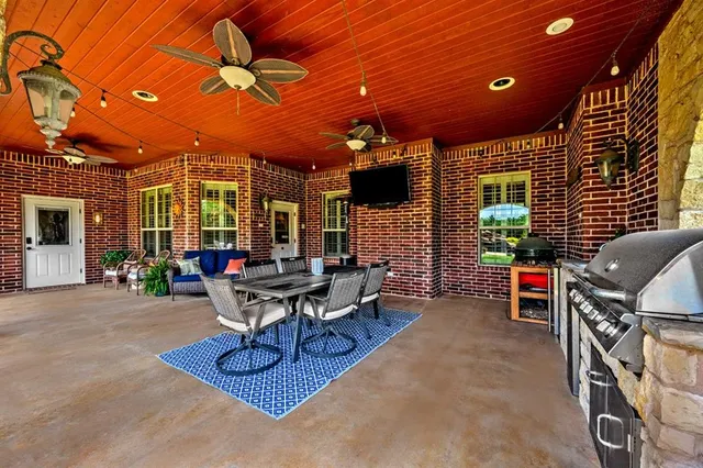 a living room with furniture a flat screen tv and a table
