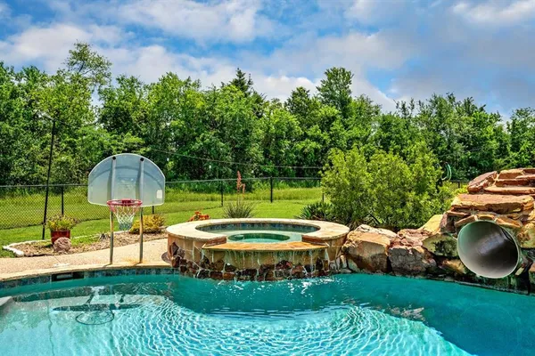 a view of a backyard with plants and a patio