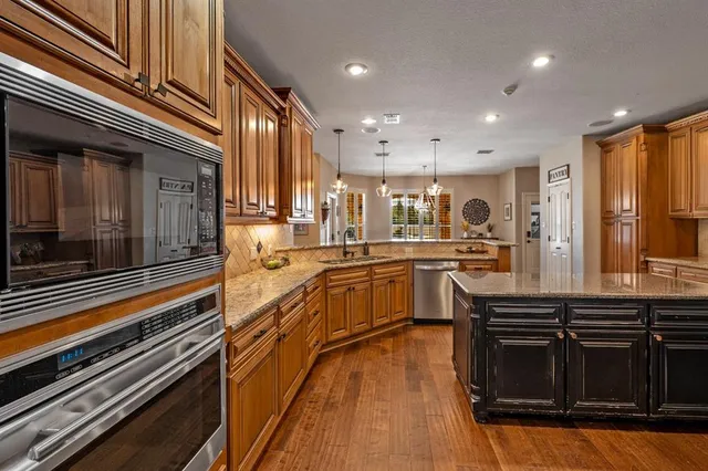 a kitchen with stainless steel appliances granite countertop a stove and a sink