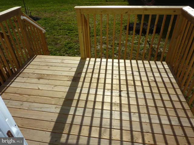 a view of a house with backyard and wooden fence