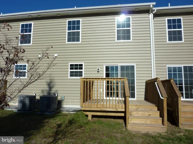 a view of a garden with a building in the background