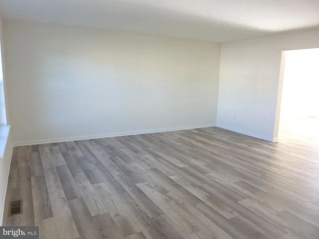 an empty room with wooden floor