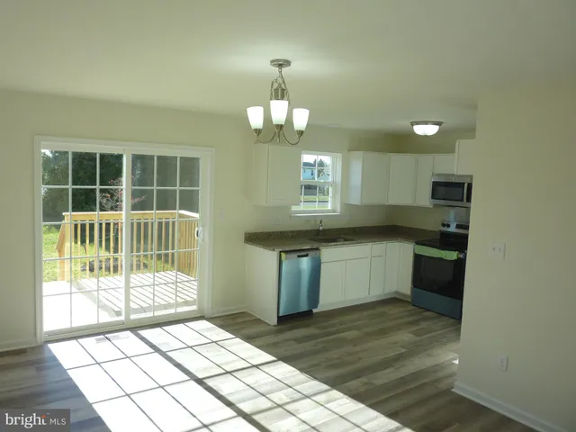 a kitchen with granite countertop a stove a sink and a granite counter top