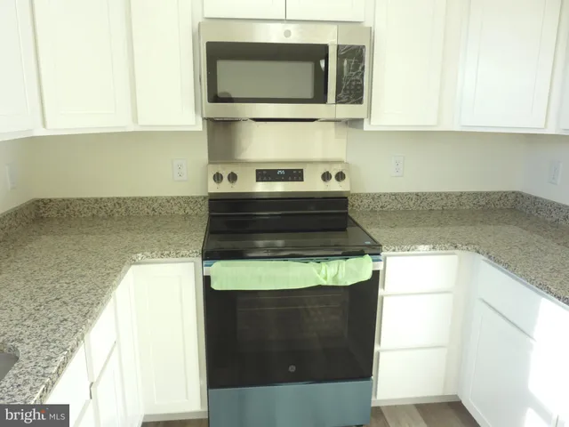 a kitchen with a stove and a microwave