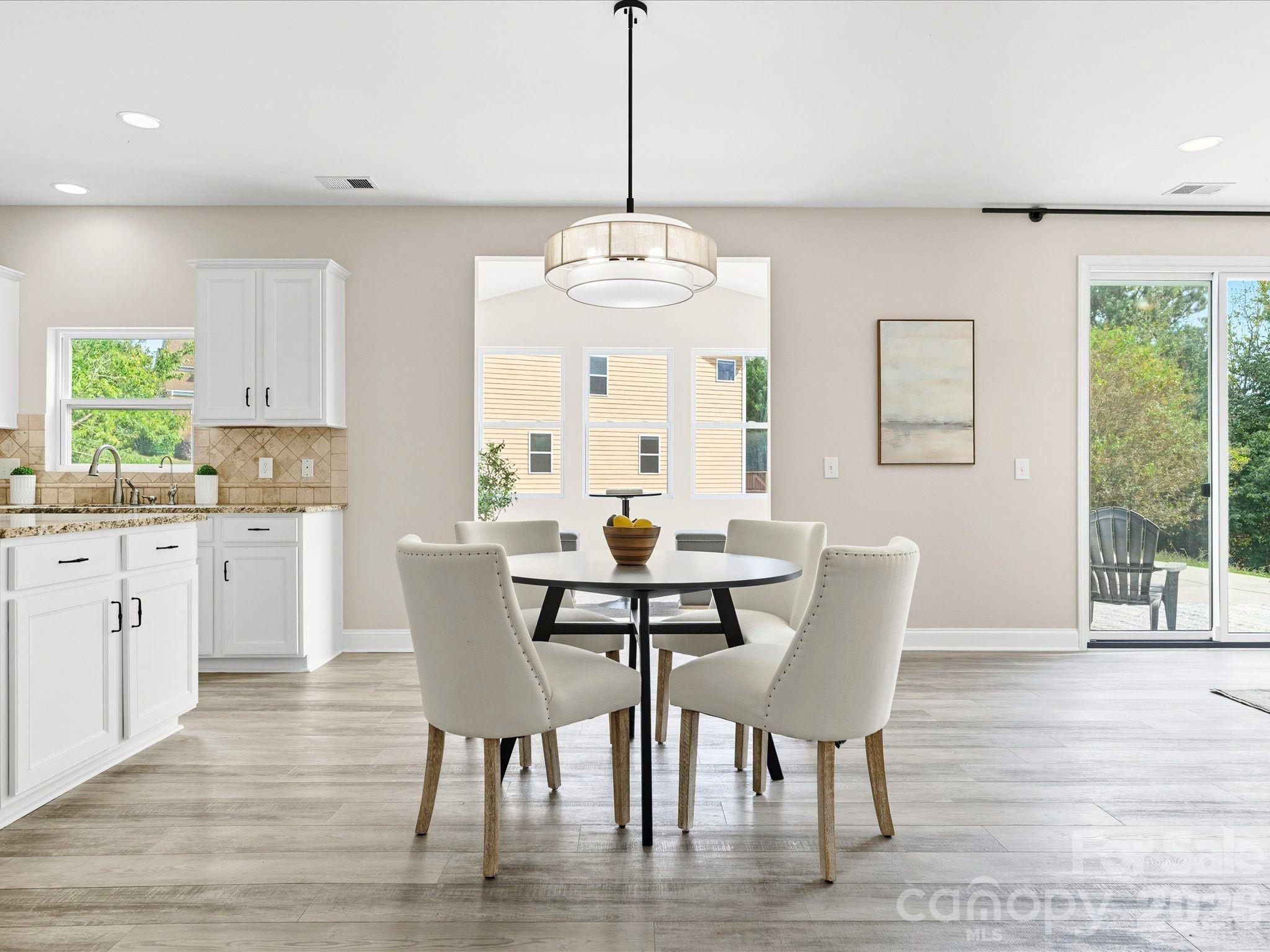 7196 Dove Field Lane Fort Mill, SC 29707 - Photo 11 of 35 a view of a dining room with furniture window and wooden floor