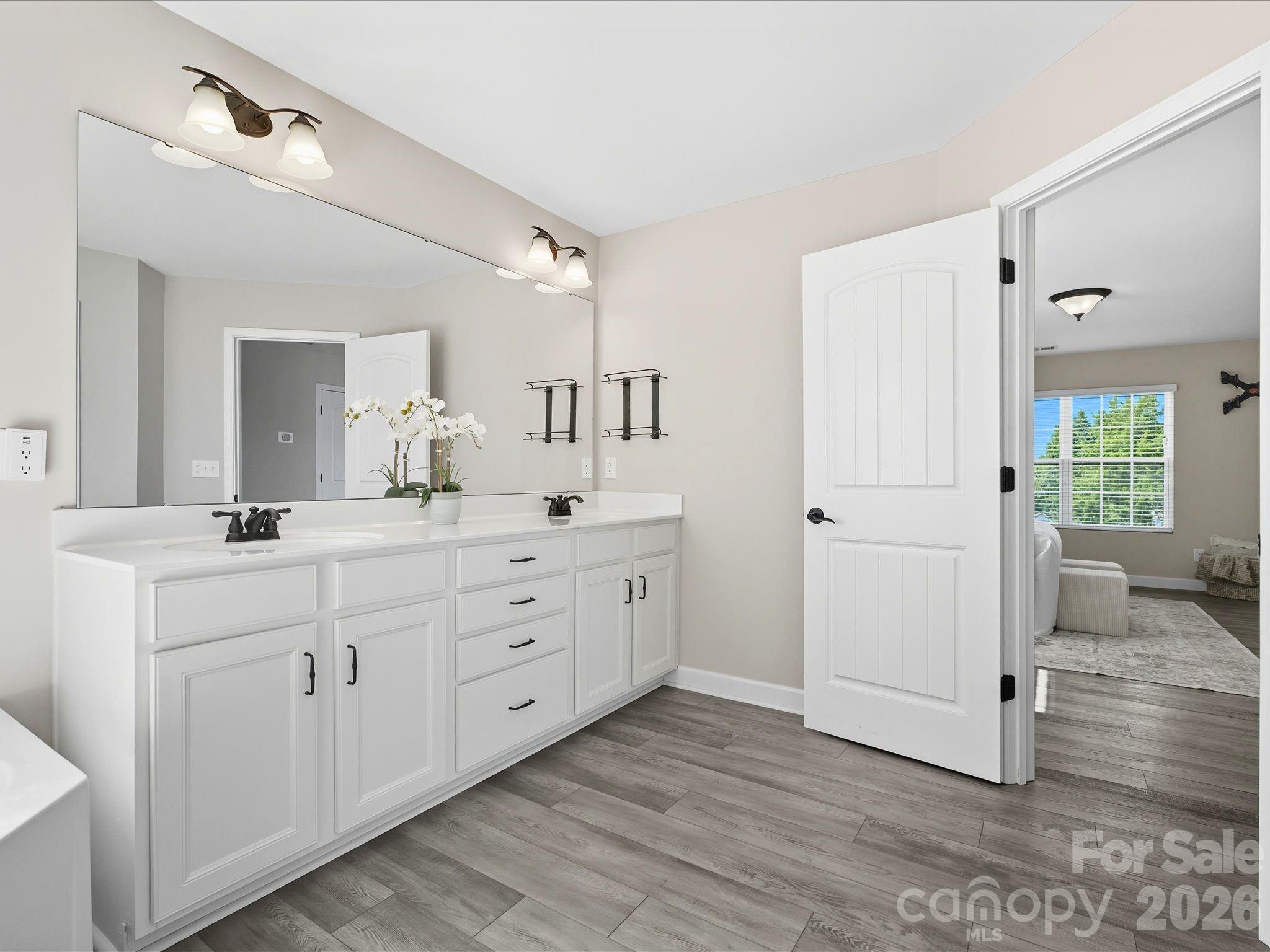 7196 Dove Field Lane Fort Mill, SC 29707 - Photo 21 of 35 a spacious bathroom with double vanity sink and a mirror