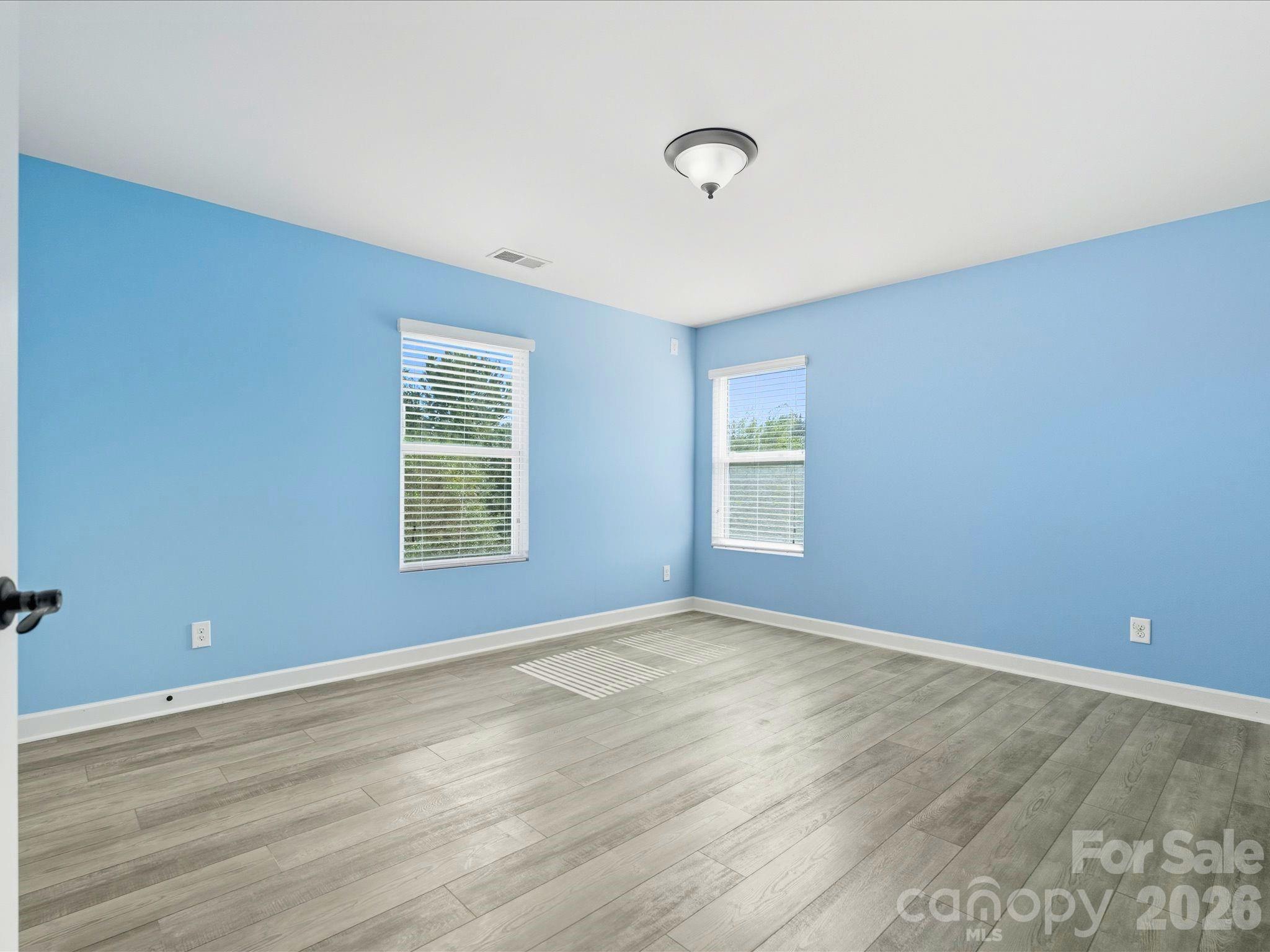 7196 Dove Field Lane Fort Mill, SC 29707 - Photo 23 of 35 wooden floor in an empty room with a window