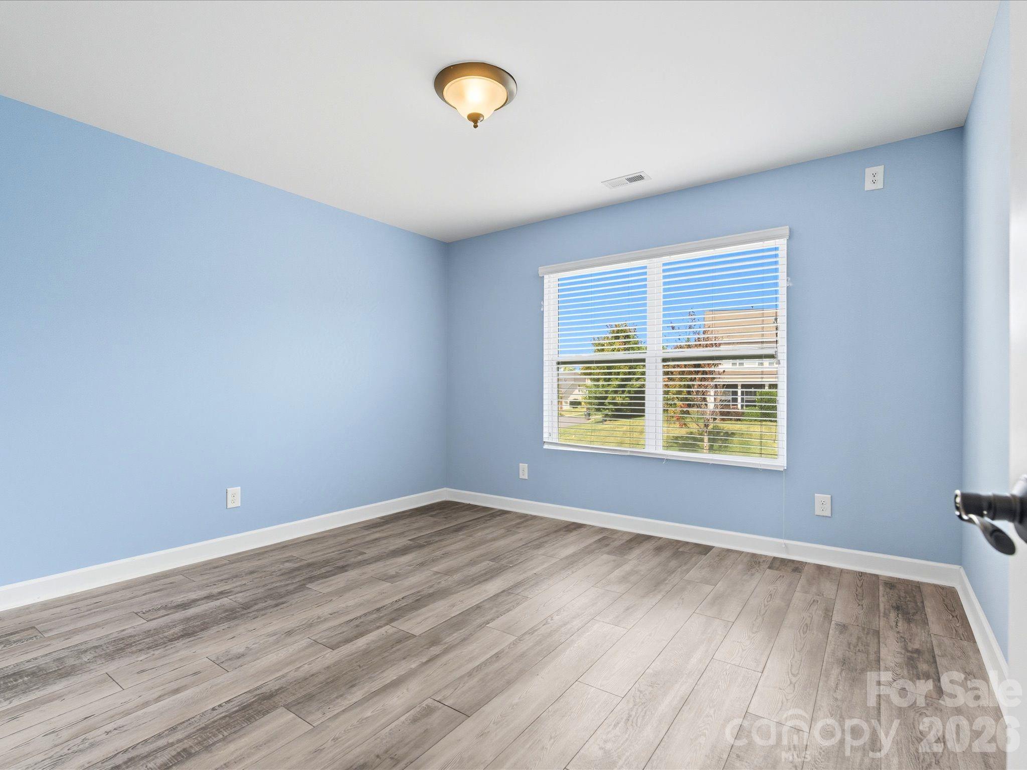 7196 Dove Field Lane Fort Mill, SC 29707 - Photo 26 of 35 wooden floor in an empty room with a window