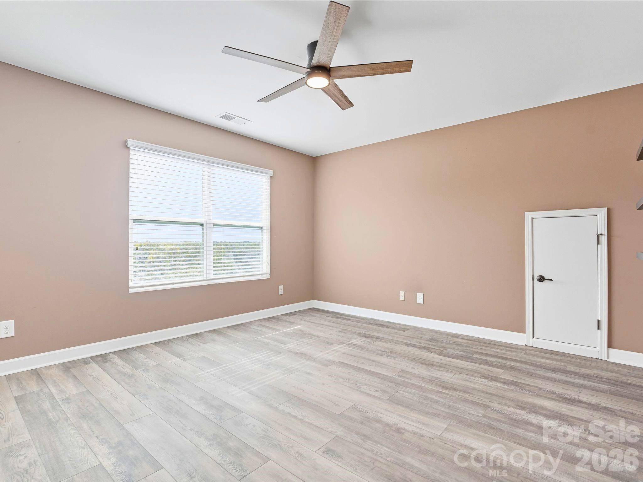 7196 Dove Field Lane Fort Mill, SC 29707 - Photo 29 of 35 wooden floor in an empty room with a window