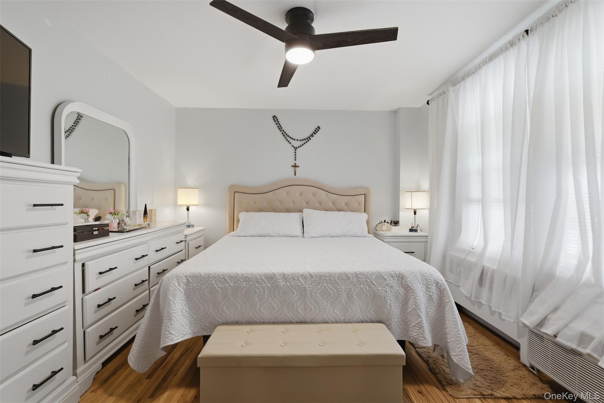 25 Trinity Place, Unit 2K New Rochelle, NY 10805 - Photo 15 of 24 This room features hardwood floors and a ceiling fan with integrated lighting.