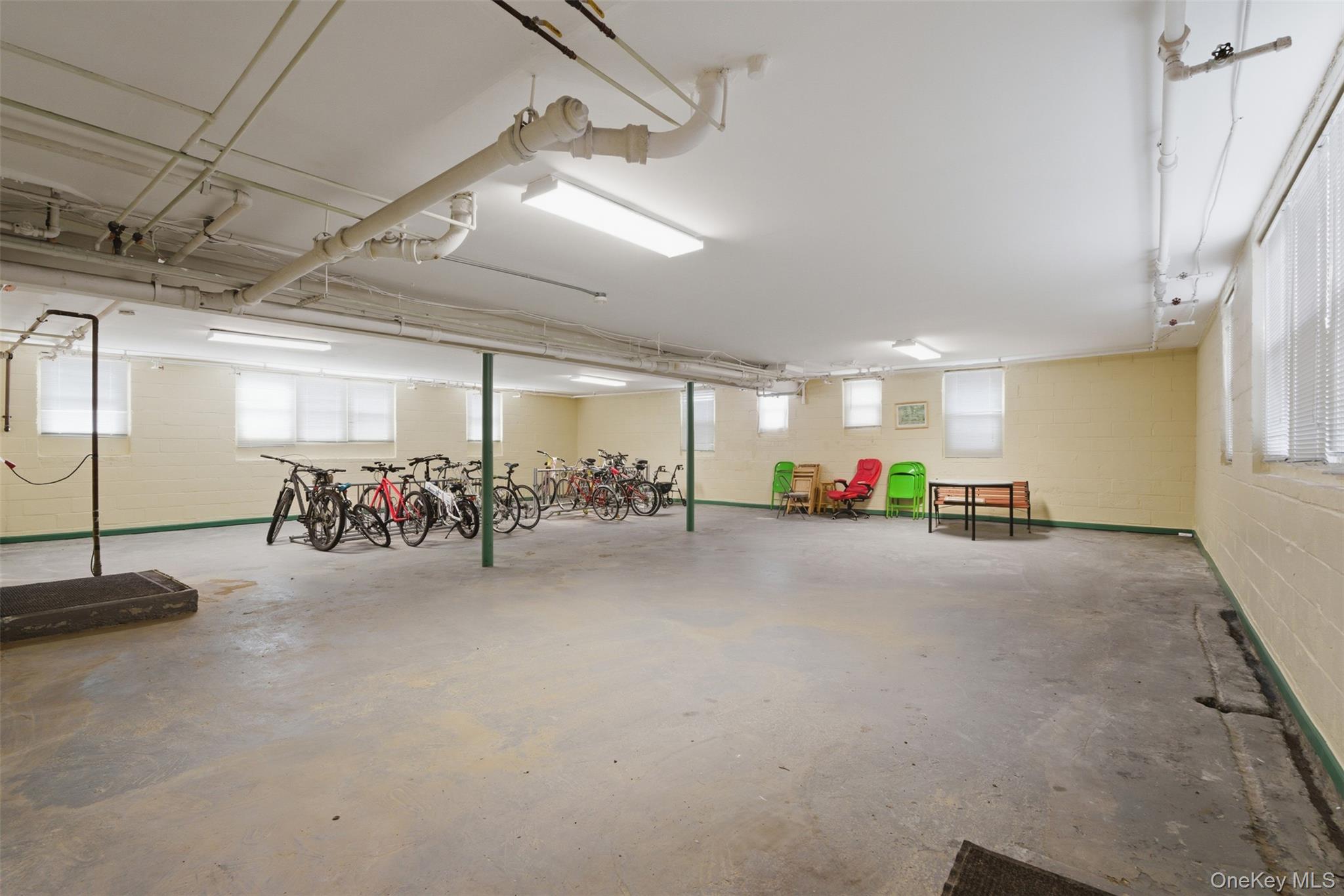 25 Trinity Place, Unit 2K New Rochelle, NY 10805 - Photo 19 of 24 Spacious basement utility area with several windows and bicycle racks.