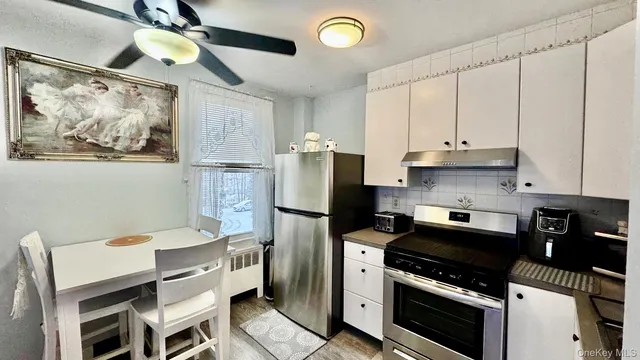 a kitchen with stainless steel appliances a stove a refrigerator and cabinets