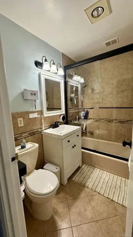 a bathroom with a toilet a sink and a mirror