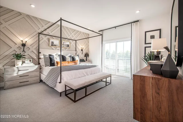 a bedroom with furniture and a large window