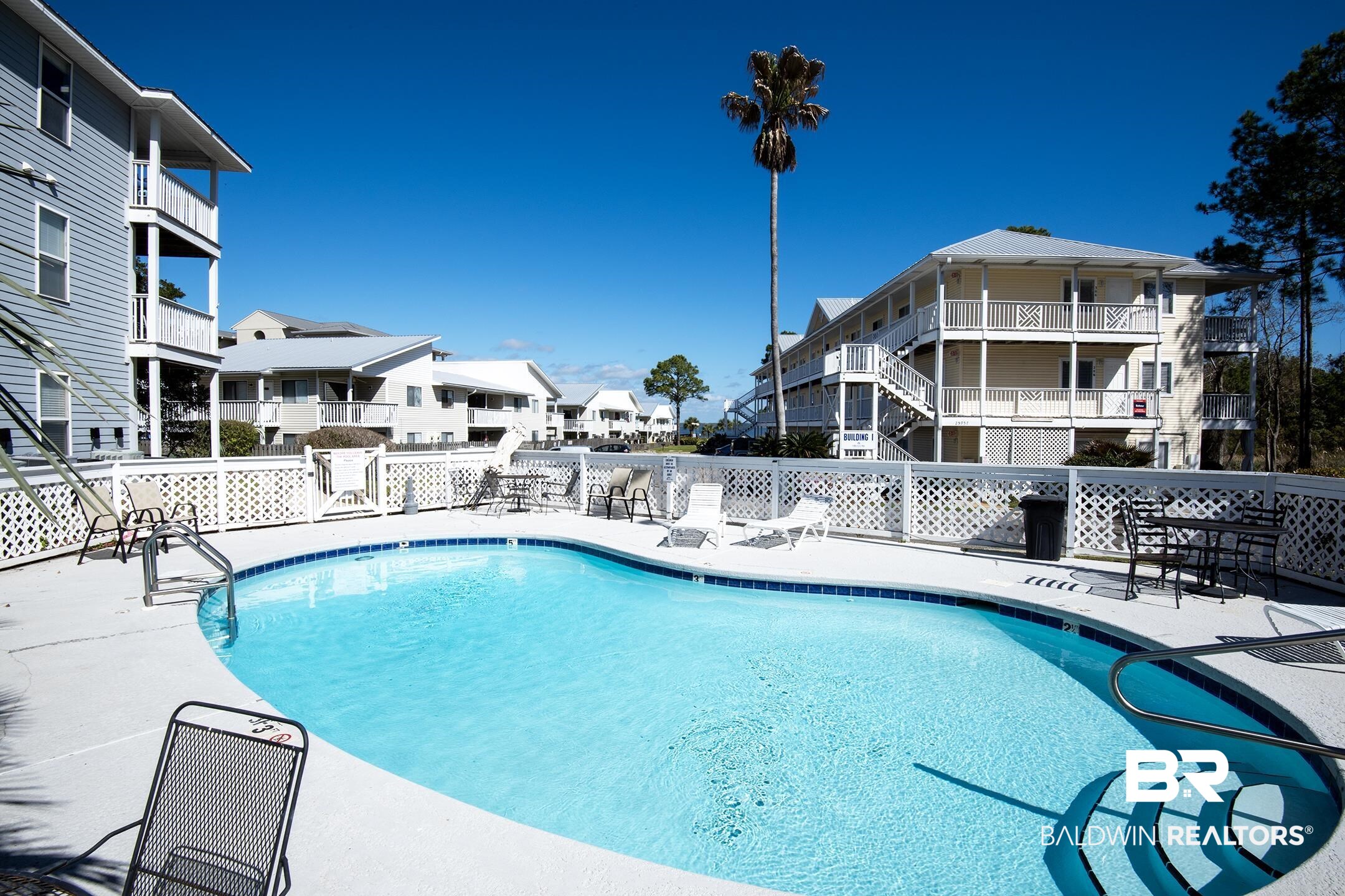 25957 Canal Road, Unit 206 Orange Beach, AL 36561 - Photo 4 of 30 Community pool featuring a patio area and a residential view