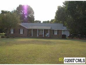 5219 Morgan Mill Road Monroe, NC 28110 - Photo 1 of 6 a front view of a house with a garden